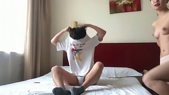 A Pair From China Engage In Intimate Activities In A Hotel Room