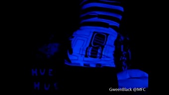 A Man'S Butt Glistening In The Black Light During A Dance Performance